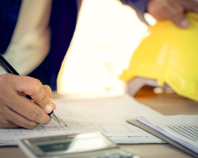 Engineer and architect working document about progress of work schedule and construction drawing on the site