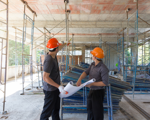 Construction concepts, Engineer and Architect working at Construction Site with blueprint