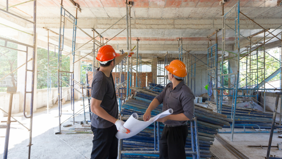 Construction concepts, Engineer and Architect working at Construction Site with blueprint